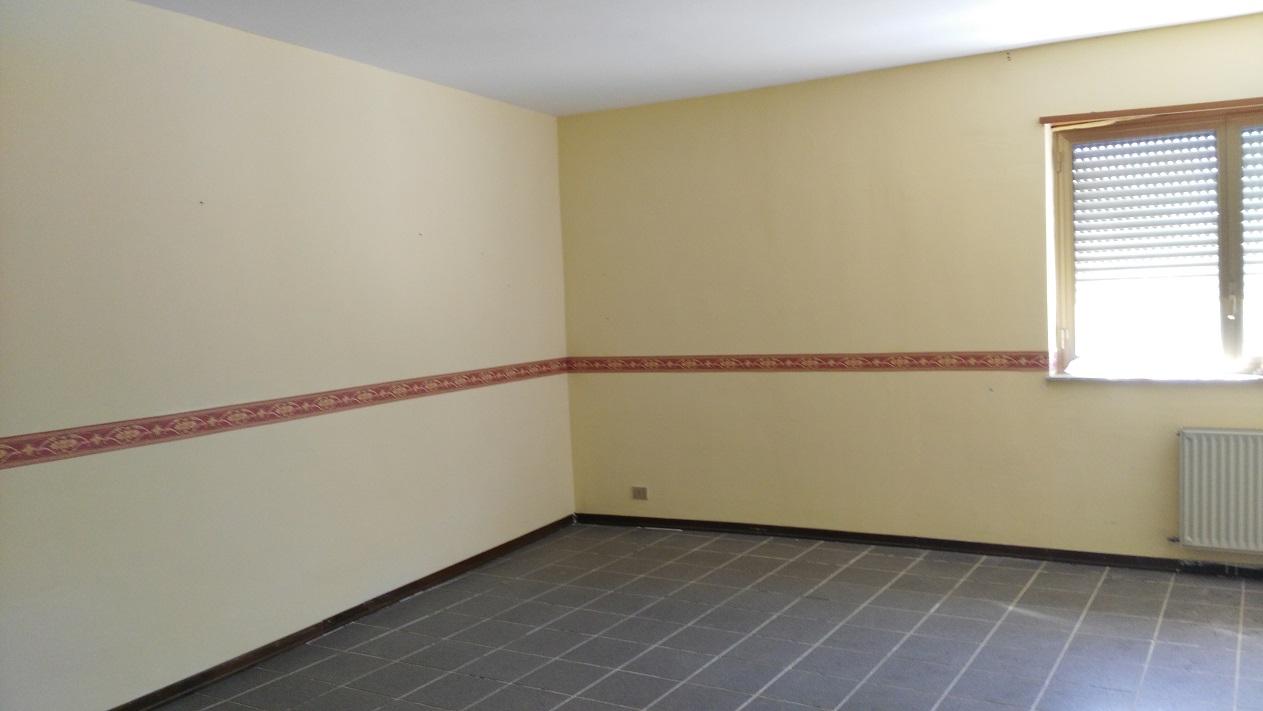 ingresso, corridoio, soggiorno, tre camere, cucina e due bagni, di cui uno con areazione meccanica. Sono presenti due balconi. Cantina piano seminterrato + posto auto esclusivo al piano seminterrato. Identificativi Catastali - [N.C.E.U.] Unità Residenziale cat. A/2 Sez. GNA foglio 5 part. 475 sub 89  - Unità Secondaria cat. C/6 Sez. GNA foglio 5 part. 475 sub 209