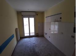 Appartamento al piano 1 costituito da cucina, soggiorno/pranzo, due camere, due bagni e due terrazze + box auto in autorimessa interrata condominiale. Identificativi Catastali [N.C.E.U.]: unità residenziale cat. A/3 foglio 48 (ex G/6) part. 1196 sub 200 rendita 464,81 e unità secondaria cat. C/6 foglio 48 (ex G/6) part. 1196 sub 50 rendita 99,16