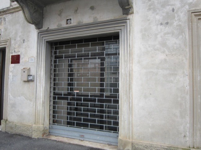 Due unità al piano terra con accesso diretto dalla via pubblica, altezza di m 3,60 circa. La prima, è costituita da un locale principale con doppio ingresso di sicurezza con ampia porta in alluminio verniciato provvista di vetro blindato e completata da serranda avvolgibile, da un piccolo locale sul retro dotato di finestra in alluminio anodizzato con inferriata, da un bagno (finestra in alluminio ed inferriata) con antibagno e da un piccolo sottoscala. La seconda unità di dimensioni ridotte con piccola porta in alluminio anodizzato e vetro con serranda avvolgibile ed è costituita da un corridoio d’ingresso lungo e stretto e da un piccolo vano sul retro dotato di finestra in alluminio anodizzato completata da un’inferriata. Sup. Sub. 3 - 43 mq, Sub. 4 -10 mq. Lotto libero piena proprietà.