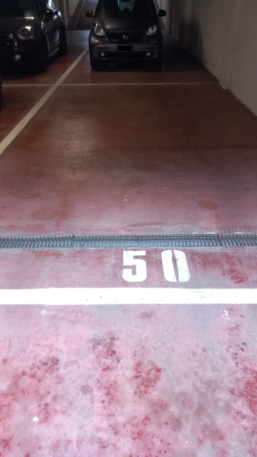 Posto auto coperto con rampa d’accesso da Largo Virgilio Brocchi n. 68, situato al piano S1 della scala B, interno 50. Id. cat. Unità Secondaria cat. C/6 foglio 853 part. 739 sub 90. Sup. mq catastali 19
